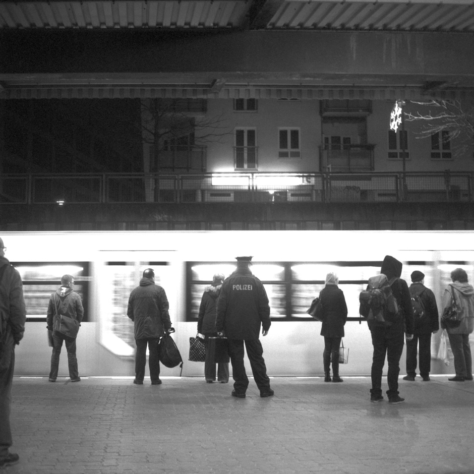 At the station of Berlin Hellersdorf (Germany) a satellite town far out in the east of the city commuters are waiting for their train to come to a halt.